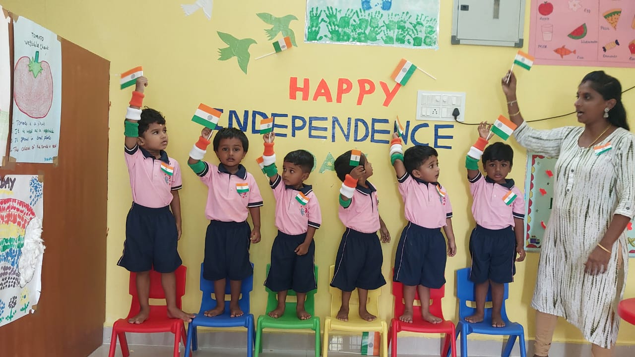 Children waving Indian flags for Independence Day role play