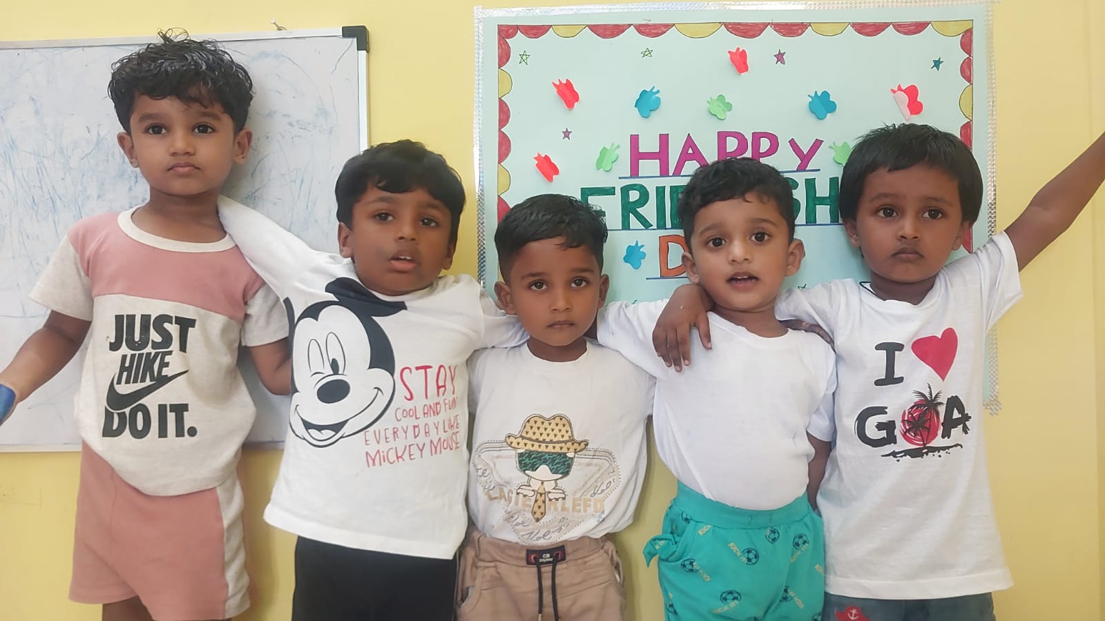 Children posing together for Friendship Day celebration