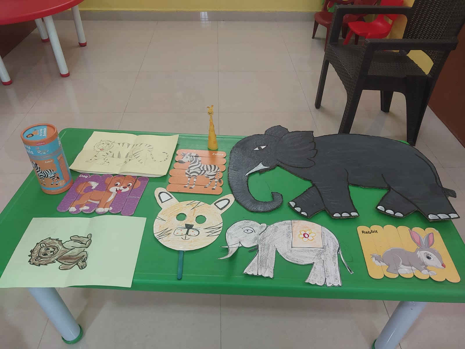 Animal paper masks and craft pieces displayed on a table